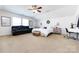 Spacious bedroom boasts vaulted ceiling, neutral carpet, large windows, plus a seating and work area at 4683 Dunberry Sw Pl, Concord, NC 28027