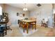 Dining room with wooden table and chairs, complemented by a textured rug, side board, and a bright window at 4683 Dunberry Sw Pl, Concord, NC 28027