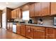 Kitchen boasts wooden cabinets, granite countertops, stainless steel appliances and hardwood floors at 4683 Dunberry Sw Pl, Concord, NC 28027