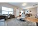 Cozy living room featuring a plush rug, comfortable seating, and natural light, creating a warm and inviting atmosphere at 4683 Dunberry Sw Pl, Concord, NC 28027