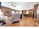 Inviting living space flowing into an open kitchen, featuring wood floors and a cozy seating arrangement at 4683 Dunberry Sw Pl, Concord, NC 28027