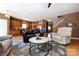 Cozy living room with an open kitchen view, featuring hardwood floors, comfortable seating, and natural light at 4683 Dunberry Sw Pl, Concord, NC 28027