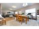 Open concept living and dining area with hardwood floors, lots of natural light, and comfortable furnishings at 4683 Dunberry Sw Pl, Concord, NC 28027