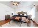 A spacious bedroom with neutral tones, wood floors and decorative accents at 4683 Dunberry Sw Pl, Concord, NC 28027