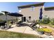 An outdoor living space boasts a concrete patio with comfortable seating, lush grass, and well-maintained landscaping at 4683 Dunberry Sw Pl, Concord, NC 28027