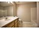 Neutral bathroom features a wooden vanity and a shower/tub combo at 4728 Cottage Oaks Dr, Charlotte, NC 28269
