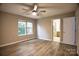 Bright bedroom features hardwood floors, a ceiling fan, and an ensuite bathroom at 4728 Cottage Oaks Dr, Charlotte, NC 28269
