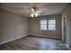 Bright bedroom with new floors, a ceiling fan, and a large window for lots of natural light at 4728 Cottage Oaks Dr, Charlotte, NC 28269