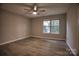 Well-lit bedroom features a ceiling fan, wood-look flooring, and a double window at 4728 Cottage Oaks Dr, Charlotte, NC 28269