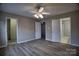 This bedroom has multiple entry points and wood-look floors at 4728 Cottage Oaks Dr, Charlotte, NC 28269