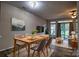 Cozy dining room featuring a modern table set, hardwood floors, and sliding doors to the outside at 4728 Cottage Oaks Dr, Charlotte, NC 28269