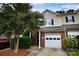 Charming townhome featuring a brick facade, attached garage, and manicured landscaping at 4728 Cottage Oaks Dr, Charlotte, NC 28269