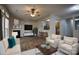 Bright living room featuring a fireplace, hardwood floors, and bar-style seating to the kitchen at 4728 Cottage Oaks Dr, Charlotte, NC 28269