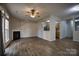 Cozy living room featuring a fireplace, new flooring and an open view into the kitchen at 4728 Cottage Oaks Dr, Charlotte, NC 28269