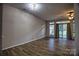Spacious living room with new flooring and a sliding glass door leading to the outside at 4728 Cottage Oaks Dr, Charlotte, NC 28269