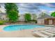 Community pool features many lounge chairs, a pool house, and mature trees at 4728 Cottage Oaks Dr, Charlotte, NC 28269
