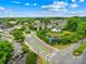 Aerial view of neighborhood entrance, with street, pond and lush trees at 4848 Fonthill Ln, Charlotte, NC 28210