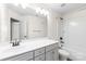 Bright bathroom with modern vanity, framed mirror, and shower-tub combination at 4848 Fonthill Ln, Charlotte, NC 28210