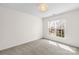 Neutral bedroom with a window, carpeted floors, and a modern light fixture at 4848 Fonthill Ln, Charlotte, NC 28210