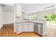 Open kitchen area with granite counters, stainless steel dishwasher, view of the living room and sliding doors at 4848 Fonthill Ln, Charlotte, NC 28210
