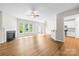 Spacious living room with fireplace, hardwood floors, ceiling fan, and lots of natural light at 4848 Fonthill Ln, Charlotte, NC 28210