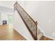 Elegant staircase with decorative iron balusters and wood railing, adjacent to the living room at 4848 Fonthill Ln, Charlotte, NC 28210