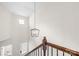 Staircase with contemporary lighting fixture and dark wood banister at 4848 Fonthill Ln, Charlotte, NC 28210
