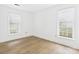 Neutral bedroom with sleek flooring, two windows, and minimalist decor at 4905 Chestnut Lake Dr, Charlotte, NC 28227