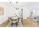Open dining room features a round table, elegant lighting, and seamless flow to the living areas and kitchen at 4905 Chestnut Lake Dr, Charlotte, NC 28227