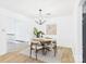 Bright dining room with a modern chandelier, round table, and neutral decor, adjacent to living spaces at 4905 Chestnut Lake Dr, Charlotte, NC 28227