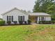Charming single-story home features a sunny yellow front door and manicured landscaping at 4905 Chestnut Lake Dr, Charlotte, NC 28227