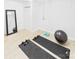 Bright workout area with wood floors, a mirror, and space for fitness equipment at 4905 Chestnut Lake Dr, Charlotte, NC 28227