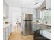 Modern kitchen featuring stainless steel appliances, sleek countertops, light gray cabinets, and wood-look flooring at 4905 Chestnut Lake Dr, Charlotte, NC 28227