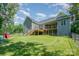 Expansive backyard featuring a wooden deck, fenced yard, and lush green grass at 5215 Star Magnolia Ct, Clover, SC 29710