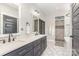 Modern bathroom featuring double vanity, hexagon tile flooring, and tiled walk-in shower at 5215 Star Magnolia Ct, Clover, SC 29710
