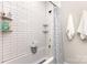 Bright bathroom with a white tiled tub/shower with storage shelves and a stylish shower curtain at 5215 Star Magnolia Ct, Clover, SC 29710