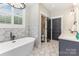 Stylish bathroom featuring a freestanding tub, marble-patterned tile, and double vanity sinks at 5215 Star Magnolia Ct, Clover, SC 29710