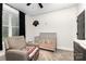 Charming bedroom with a gray crib, comfortable chair, and soft carpeting at 5215 Star Magnolia Ct, Clover, SC 29710