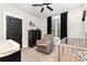 Bedroom with a ceiling fan, a crib, a plush chair, and a dresser under a window at 5215 Star Magnolia Ct, Clover, SC 29710