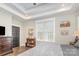 Calm bedroom with modern gray accents, tray ceiling, and wood-look flooring at 5215 Star Magnolia Ct, Clover, SC 29710