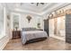 Spacious bedroom featuring a tray ceiling, hardwood floors, and ensuite bathroom with sliding barn door at 5215 Star Magnolia Ct, Clover, SC 29710