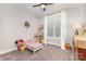Cozy bedroom with playful decor, plush carpeting, and bright natural light from the window at 5215 Star Magnolia Ct, Clover, SC 29710