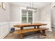 Cozy dining room features a wooden table, bench seating, rustic light fixture, and natural light from the window at 5215 Star Magnolia Ct, Clover, SC 29710