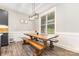 Bright dining room featuring a rustic wooden table, bench seating, and a large window at 5215 Star Magnolia Ct, Clover, SC 29710