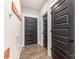 Hallway with multiple black doors and a coat rack, providing a functional and stylish entrance at 5215 Star Magnolia Ct, Clover, SC 29710