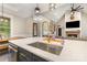 Beautiful kitchen island featuring a stainless sink, gold fixtures, and modern lighting at 5215 Star Magnolia Ct, Clover, SC 29710