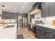 Modern kitchen with gray cabinets, stainless steel appliances, a spacious counter, and gold hardware at 5215 Star Magnolia Ct, Clover, SC 29710