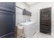 Laundry room equipped with a washer and dryer, overhead cabinets, and stylish tile flooring at 5215 Star Magnolia Ct, Clover, SC 29710