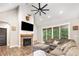 Spacious living room with a brick fireplace, vaulted ceilings, and a comfortable sectional sofa at 5215 Star Magnolia Ct, Clover, SC 29710