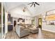 Inviting living room and kitchen with hardwood floors, vaulted ceilings, and a large comfy couch at 5215 Star Magnolia Ct, Clover, SC 29710